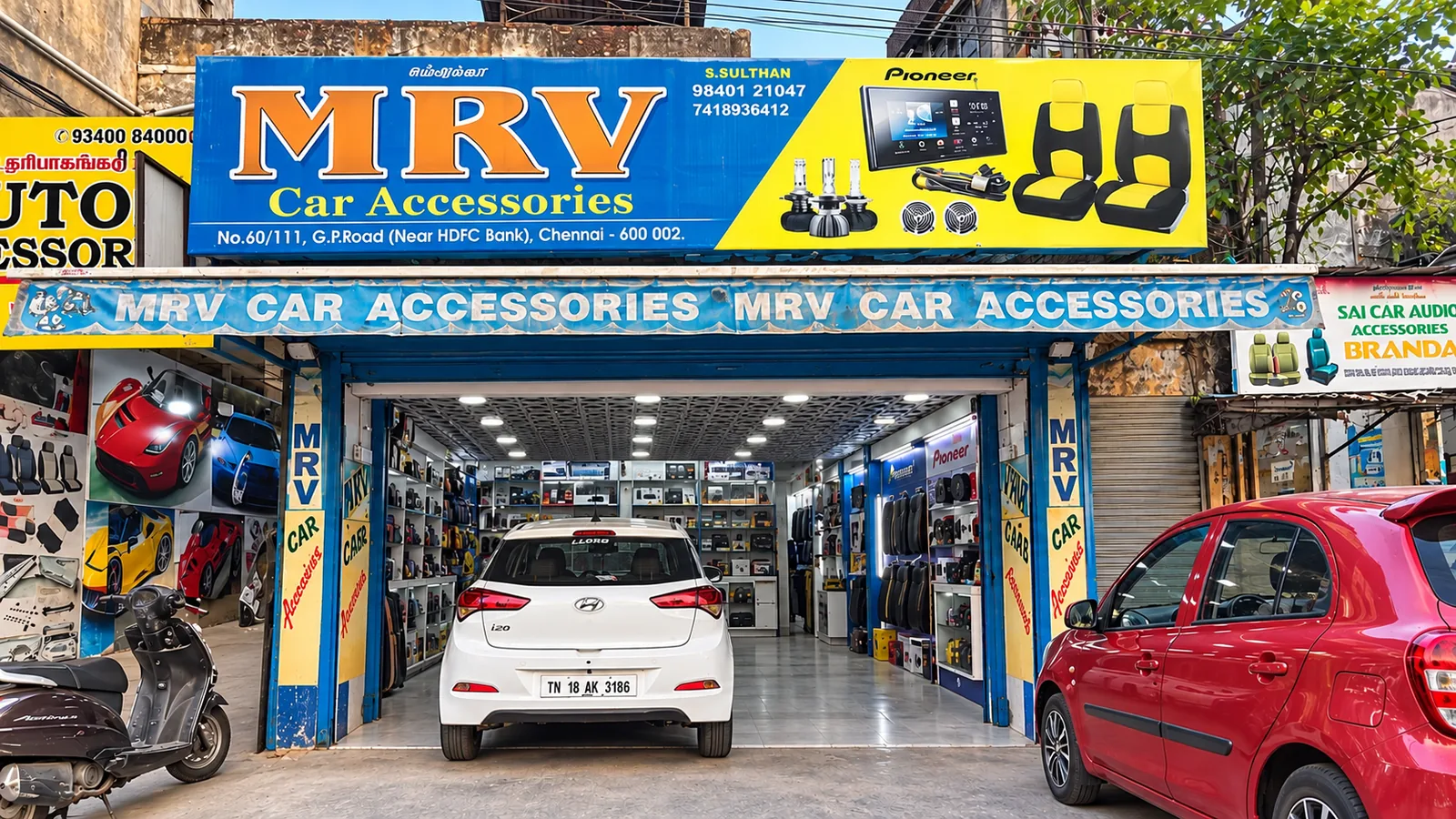 MRV storefront and vehicles in front of the shop